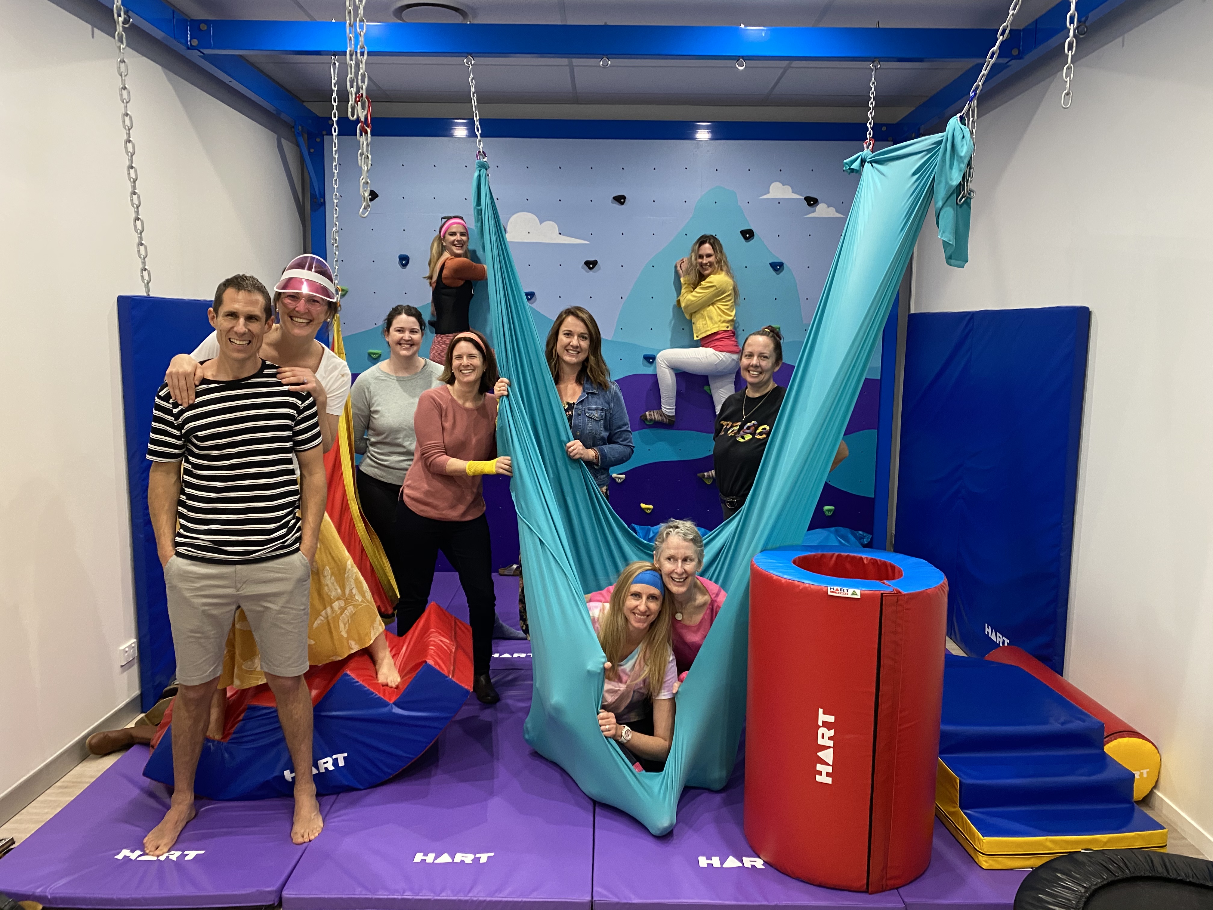 A therapy centre in front of a bouldering wall.