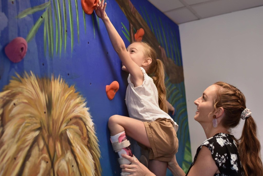 girl climbing on therapy rock climbing wall 